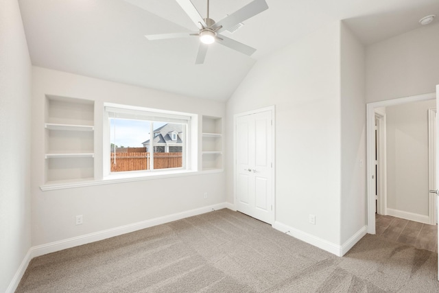 unfurnished bedroom with ceiling fan, a closet, carpet, and vaulted ceiling