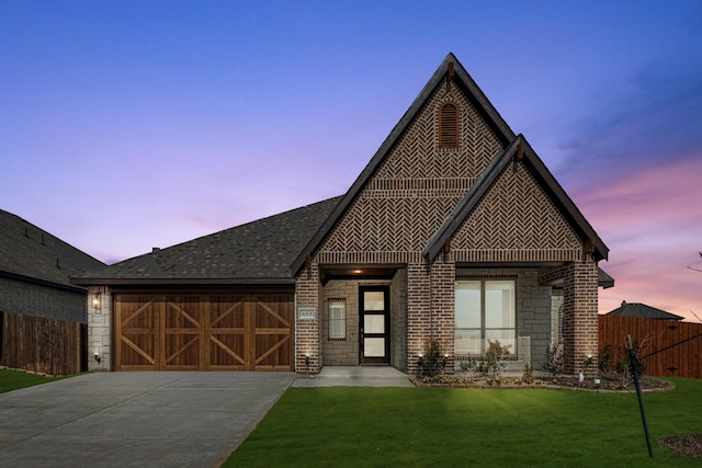 view of front of house with a garage and a lawn