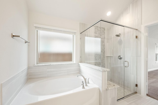 bathroom featuring separate shower and tub