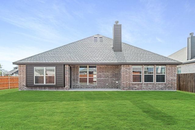 rear view of house featuring a patio and a yard