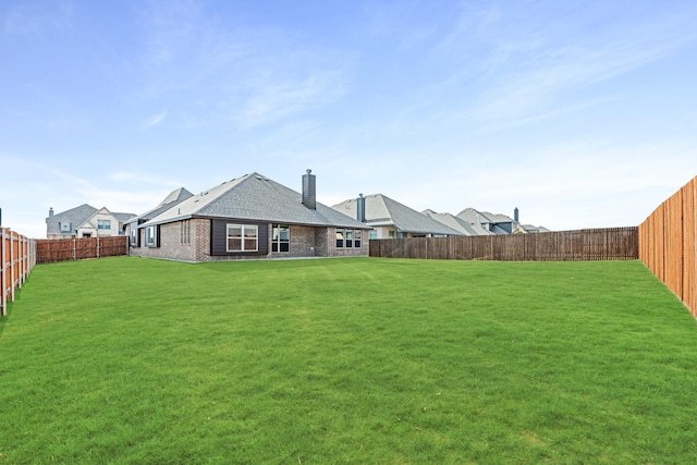 back of house featuring a yard