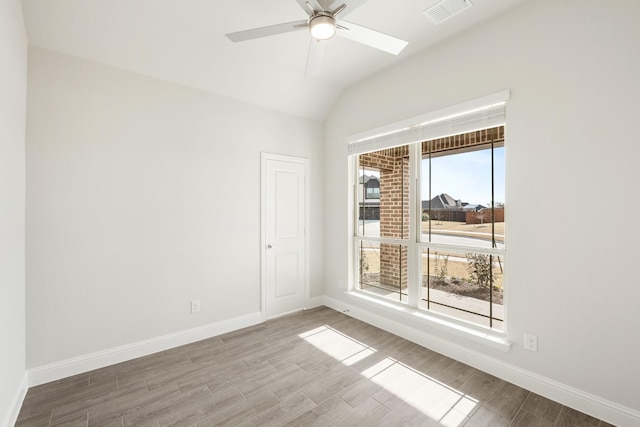 empty room featuring ceiling fan and vaulted ceiling