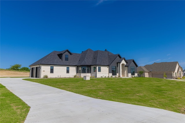 french country inspired facade with a front lawn and a garage