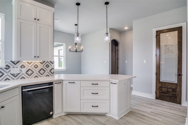 kitchen featuring light wood-type flooring, dishwasher, white cabinetry, and decorative light fixtures