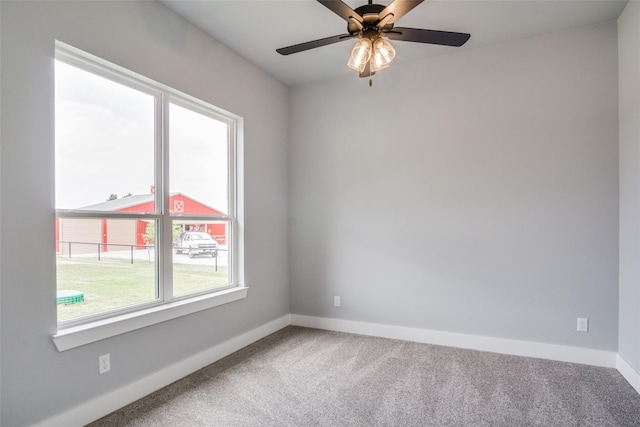 carpeted spare room with ceiling fan