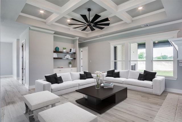 living room featuring light wood-type flooring, ceiling fan, coffered ceiling, and crown molding