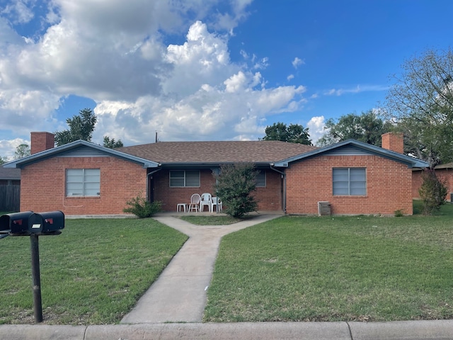 single story home featuring a front lawn and central AC