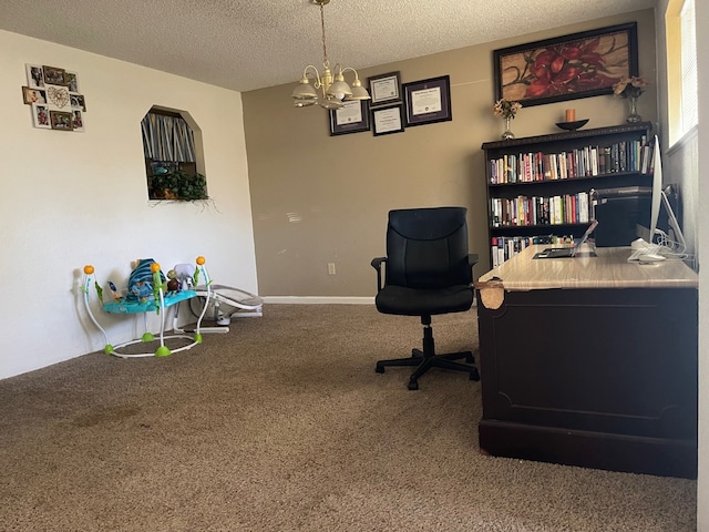 home office featuring a notable chandelier, carpet, and a textured ceiling