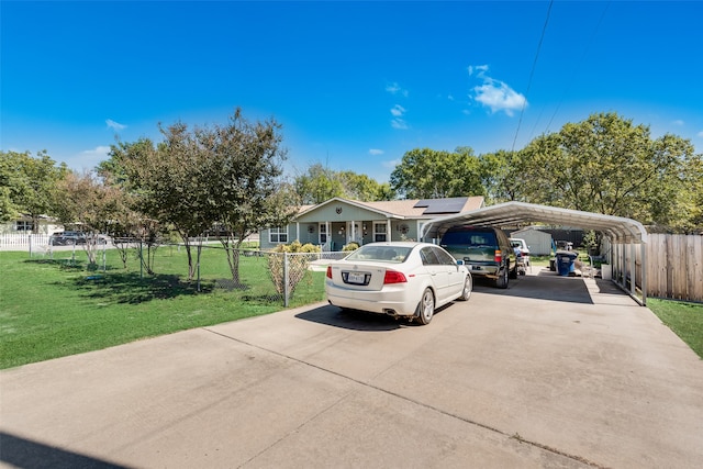 view of front of property with a front lawn and a carport