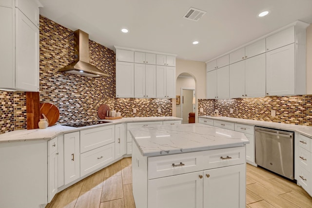 kitchen featuring wall chimney exhaust hood, a center island, dishwasher, and tasteful backsplash