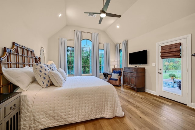 bedroom featuring access to exterior, lofted ceiling, light hardwood / wood-style flooring, and multiple windows