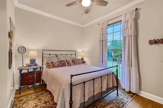 bedroom with ceiling fan, wood-type flooring, and ornamental molding