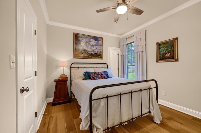 bedroom with wood-type flooring, ceiling fan, and ornamental molding