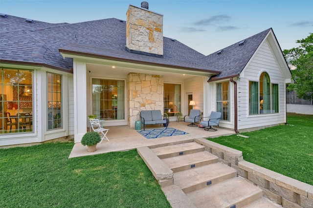 back of house featuring a yard and a patio