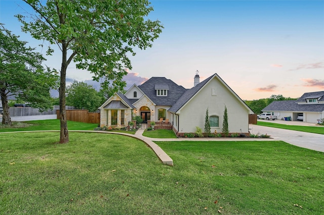 french country style house featuring a lawn