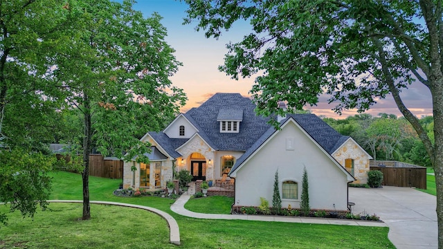 french country home with a lawn