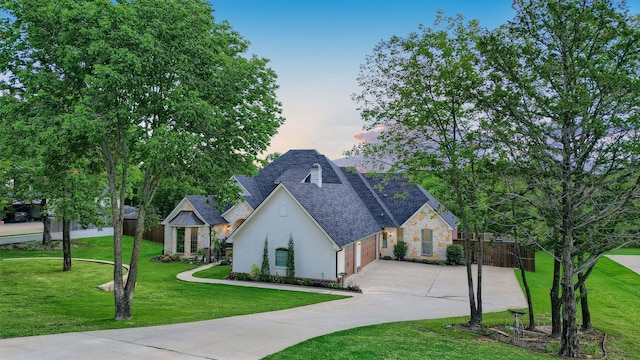 view of front of property with a lawn and a garage