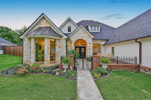 view of front facade featuring a yard and french doors