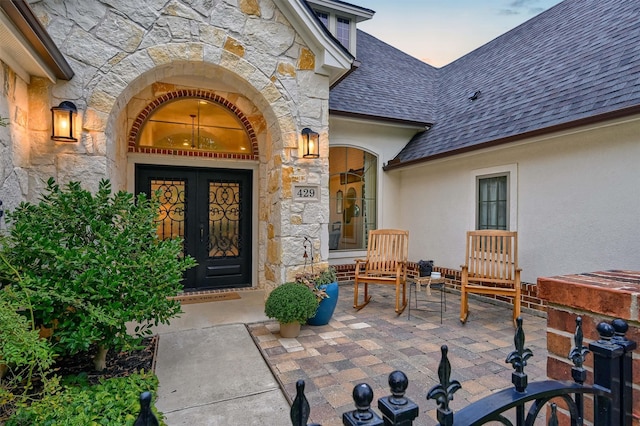 exterior entry at dusk featuring french doors