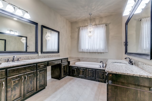 bathroom with tile patterned floors, a tub to relax in, vanity, and a notable chandelier