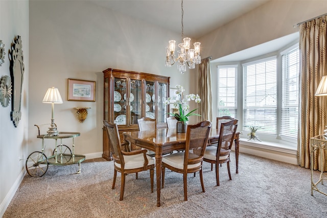 dining space featuring a chandelier and light colored carpet