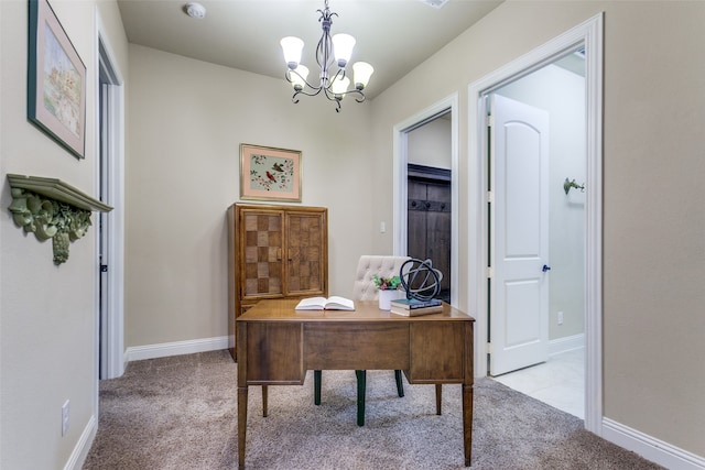 home office with light carpet and an inviting chandelier