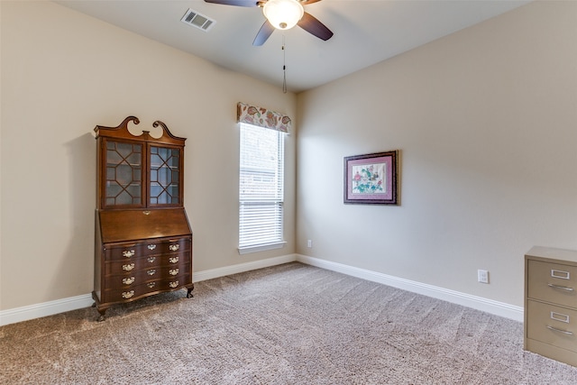 empty room with ceiling fan and carpet floors