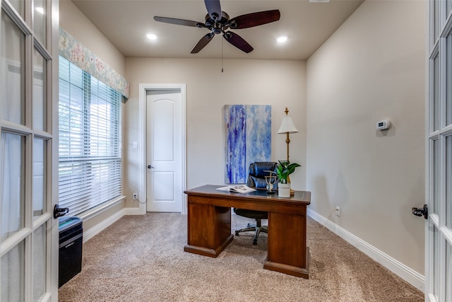 office with french doors, plenty of natural light, light carpet, and ceiling fan