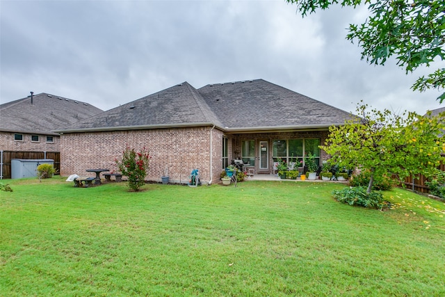 back of property featuring a patio and a yard