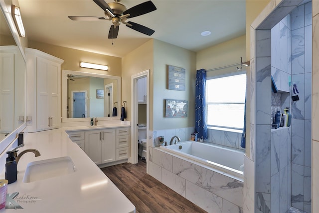 full bathroom with hardwood / wood-style floors, vanity, toilet, and ceiling fan