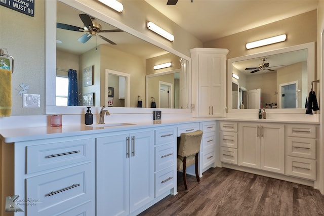 bathroom with hardwood / wood-style floors, ceiling fan, and vanity