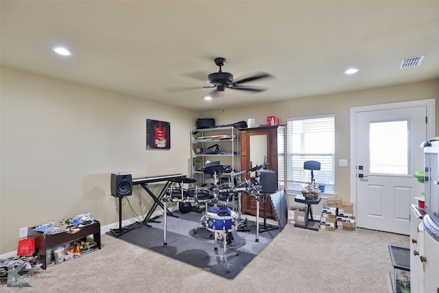 workout area with carpet and ceiling fan