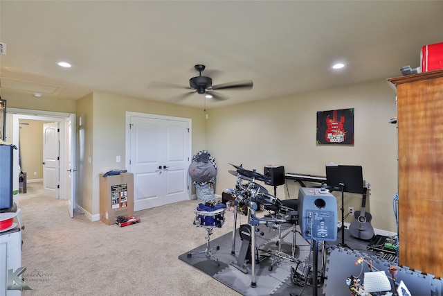 exercise area featuring ceiling fan and carpet flooring