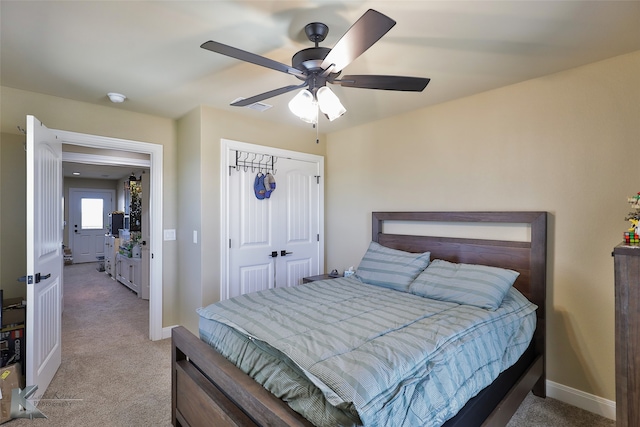 bedroom featuring ceiling fan, a closet, and carpet flooring