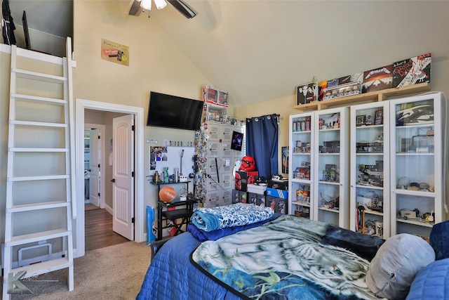 bedroom with hardwood / wood-style floors, ceiling fan, and high vaulted ceiling