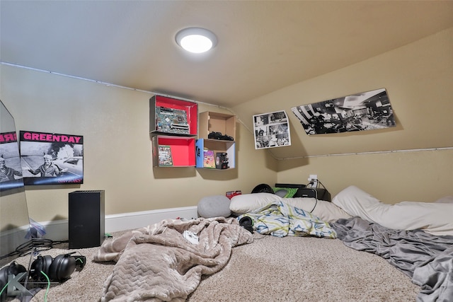 bedroom with lofted ceiling and carpet flooring