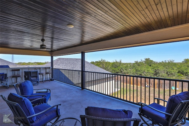 view of patio featuring ceiling fan and a balcony