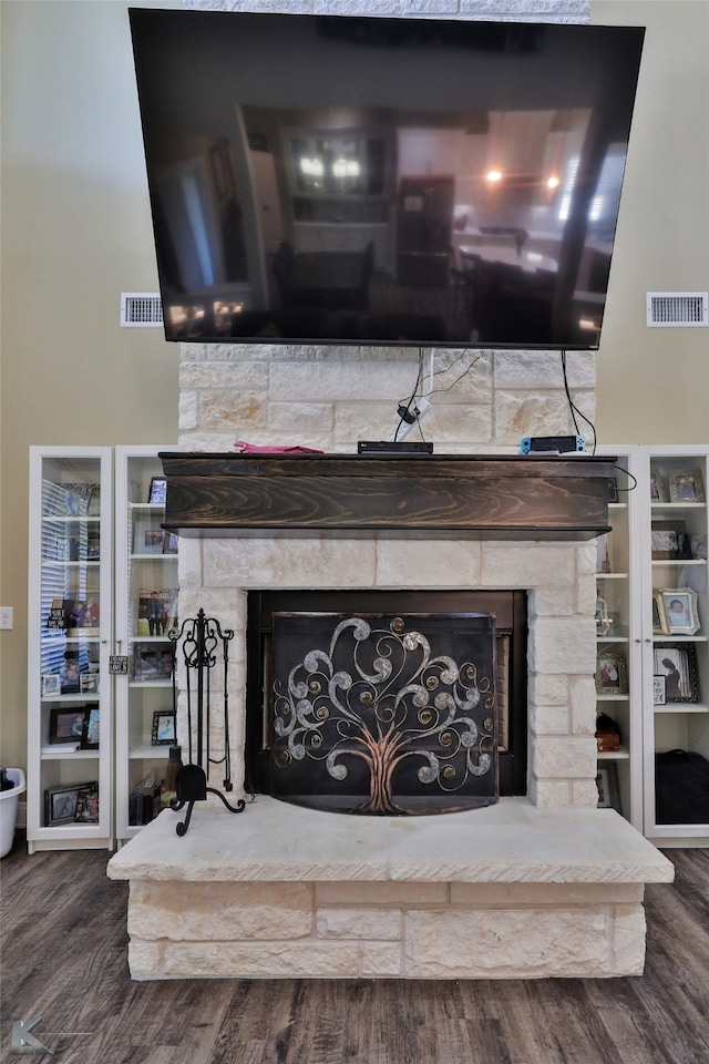 details featuring a stone fireplace and hardwood / wood-style flooring