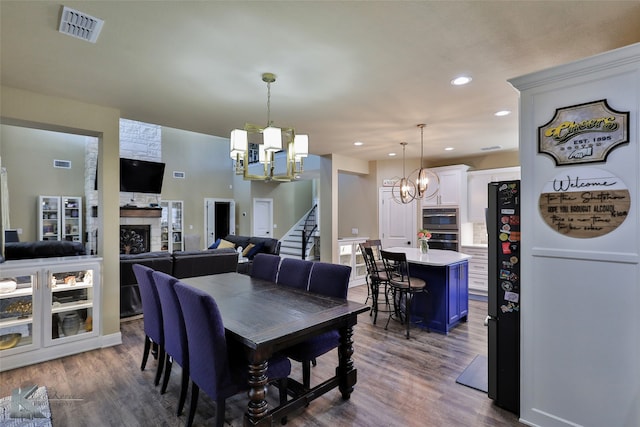 dining room with dark hardwood / wood-style flooring and a chandelier