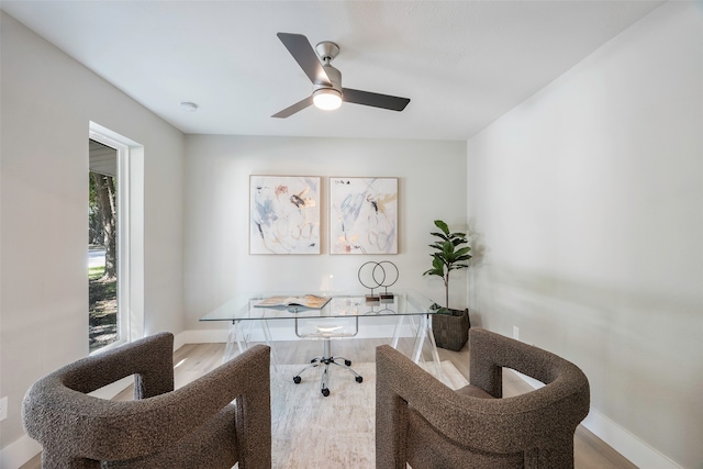 office with light hardwood / wood-style floors and ceiling fan