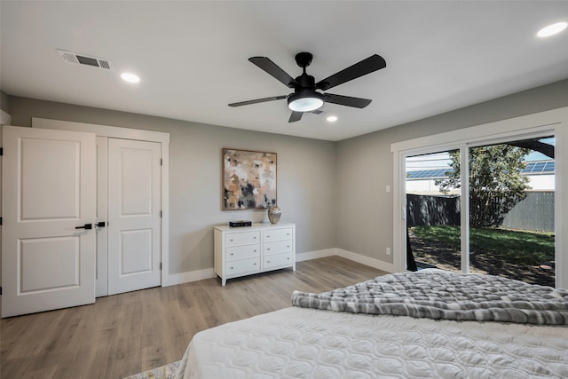 bedroom with light hardwood / wood-style floors, ceiling fan, a closet, and access to outside