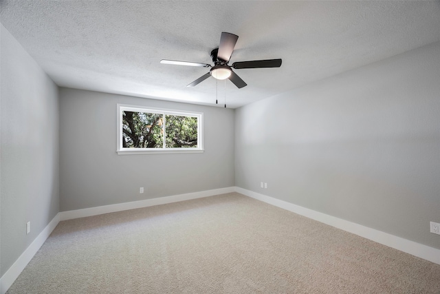 empty room featuring a textured ceiling, carpet flooring, and ceiling fan