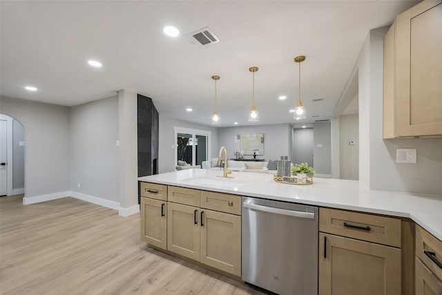 kitchen with light hardwood / wood-style floors, sink, stainless steel dishwasher, light brown cabinets, and decorative light fixtures