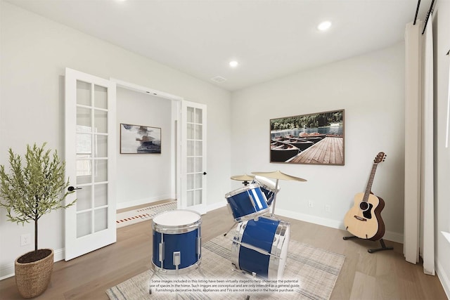 sitting room featuring french doors and hardwood / wood-style floors