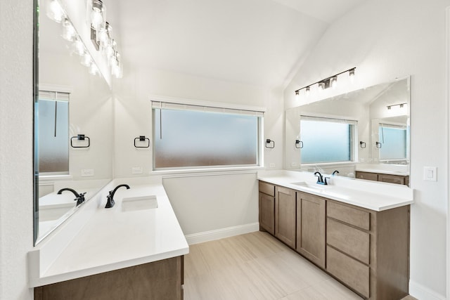 bathroom featuring vanity and vaulted ceiling