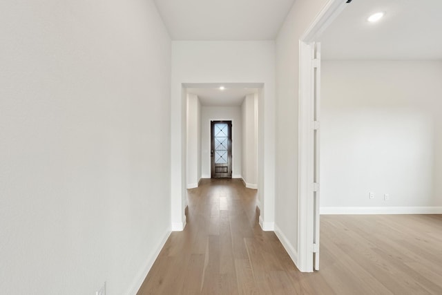 corridor with light hardwood / wood-style flooring