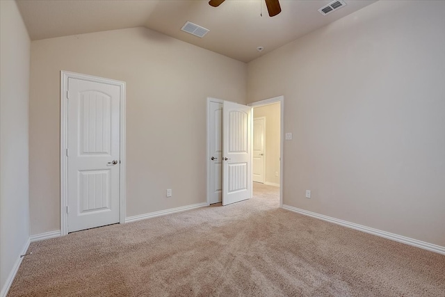 unfurnished bedroom featuring lofted ceiling, ceiling fan, and light colored carpet