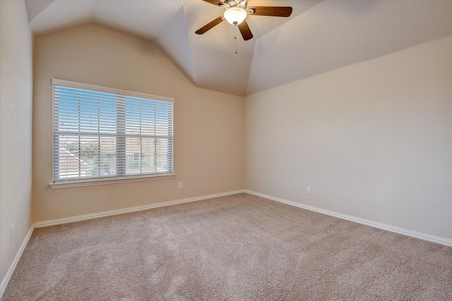 spare room featuring carpet floors, vaulted ceiling, and ceiling fan