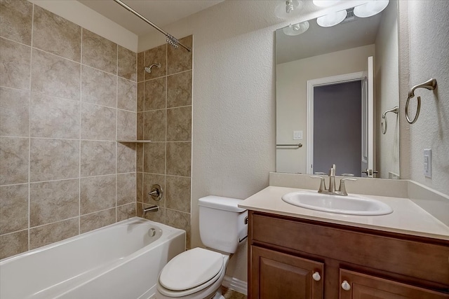 full bathroom with vanity, toilet, and tiled shower / bath