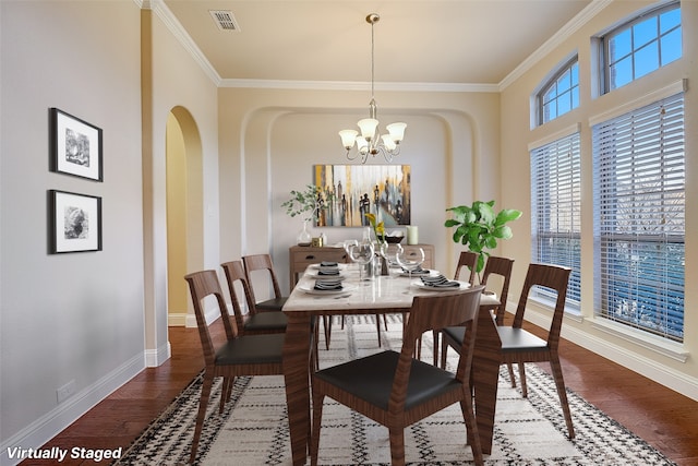 dining room featuring a notable chandelier, crown molding, and dark hardwood / wood-style flooring